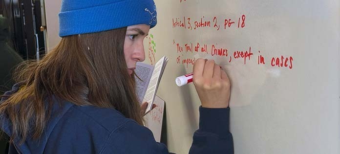 Writers Studio student writing on a whiteboard