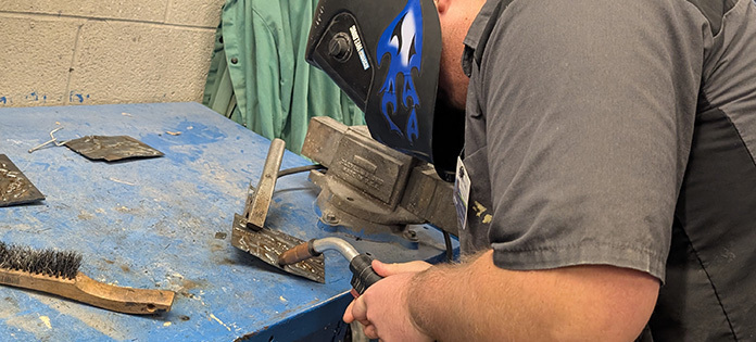 Image of Collision Repair Student welding.